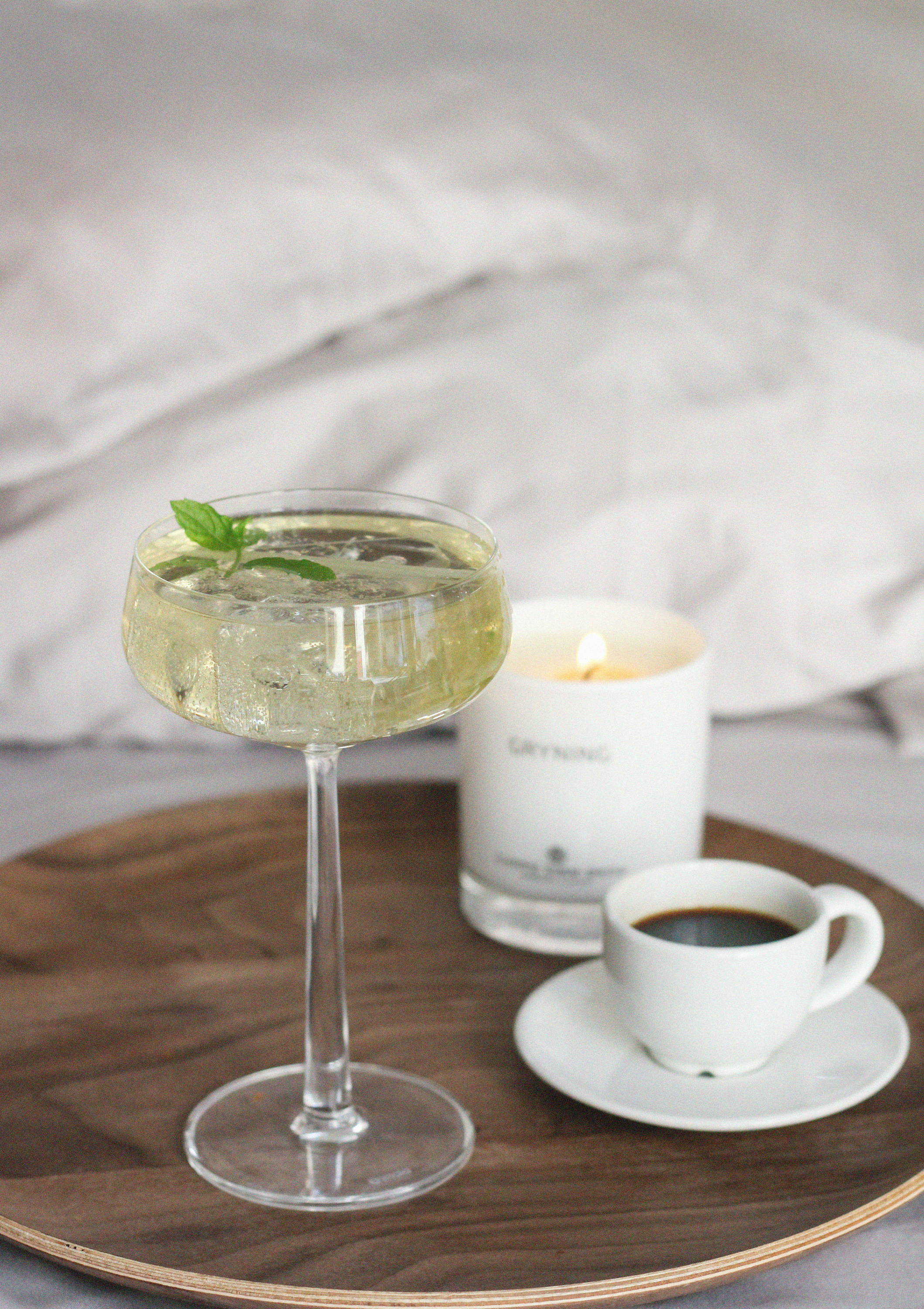 Small espresso cup, tall drink, and white scented candle